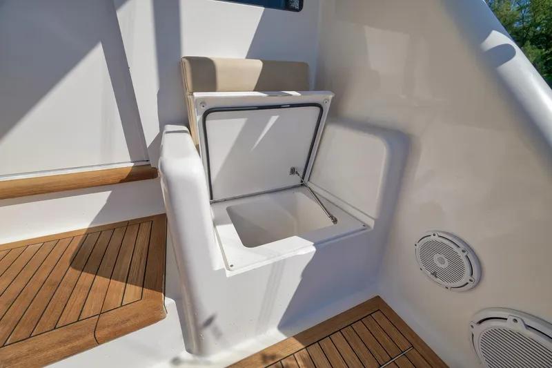 Slide: The Image of Viking 82 Convertible 2010 yacht interior with open storage compartment and wooden flooring. - 25