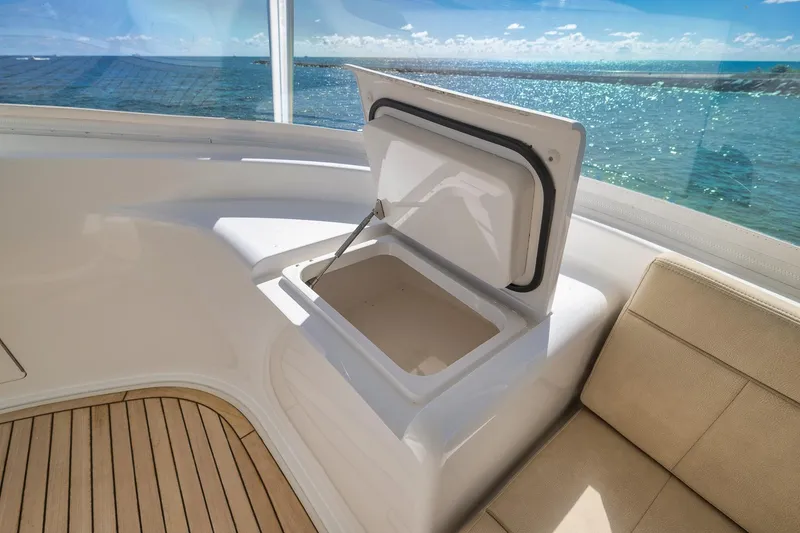 Slide: The Image of Luxurious 2010 Viking 82 Convertible yacht interior with open storage compartment and ocean view. - 33