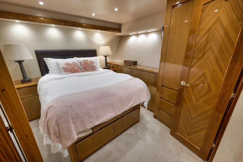 Slide: The Image of Luxurious bedroom interior on 2010 Viking 82 Convertible yacht, featuring elegant wood finishes. - 58