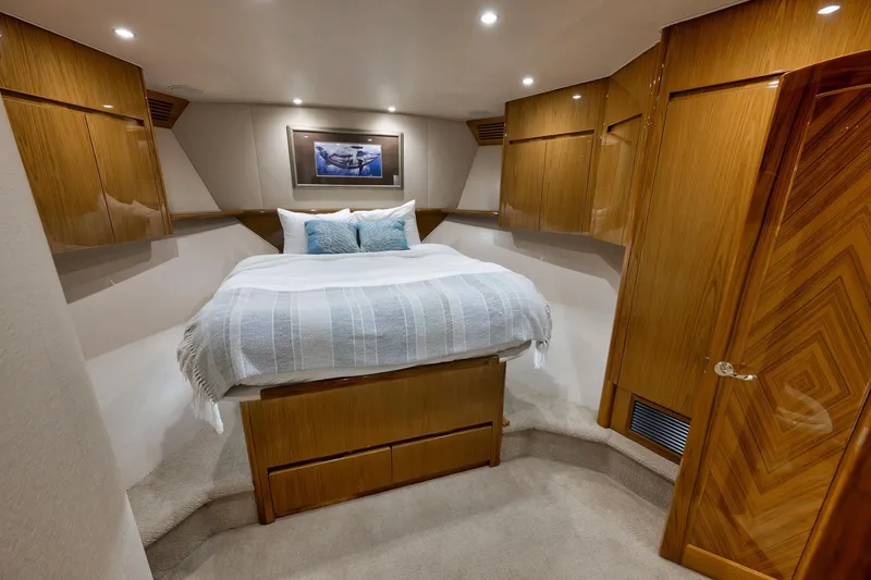Slide: The Image of Luxurious bedroom interior of 2010 Viking 82 Convertible yacht with wooden cabinetry. - 60