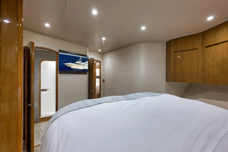 Slide: The Image of Luxurious bedroom interior of 2010 Viking 82 Convertible yacht with modern wood finishes. - 61