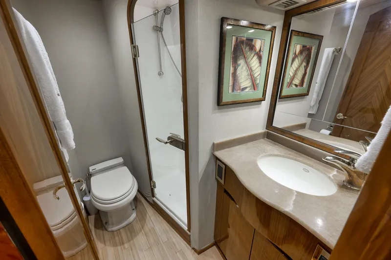 Slide: The Image of Luxurious bathroom in 2010 Viking 82 Convertible yacht with shower, toilet, and elegant vanity. - 62