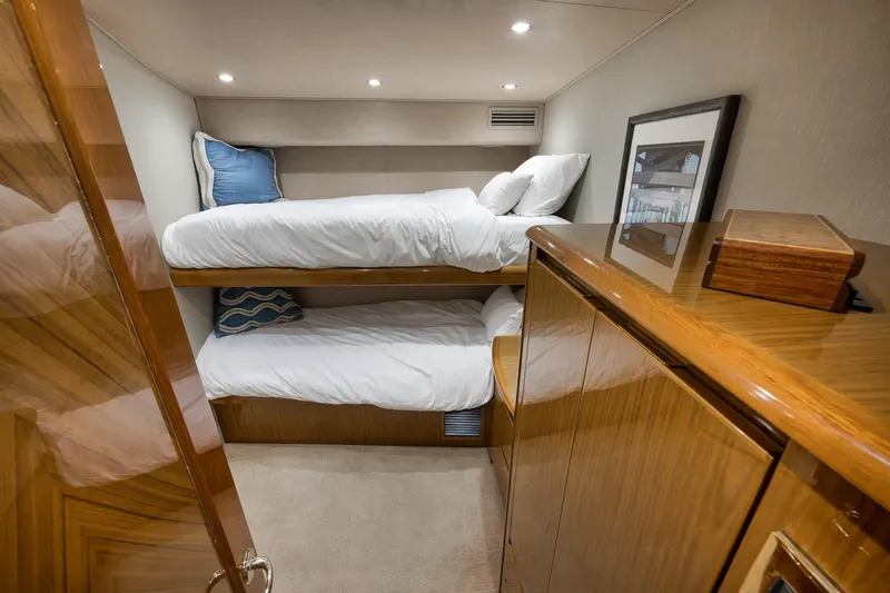Slide: The Image of 2010 Viking 82 Convertible yacht cabin with bunk beds and wooden cabinetry. - 64
