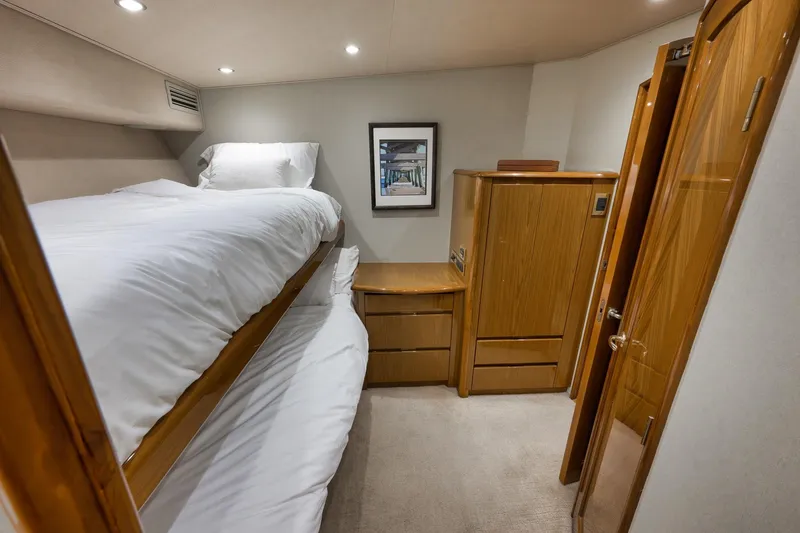Slide: The Image of Interior of 2010 Viking 82 Convertible yacht with bunk beds and wooden cabinetry. - 65