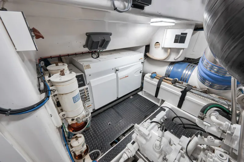 Slide: The Image of Engine room of 2010 Viking 82 Convertible yacht, featuring generator and mechanical components. - 71