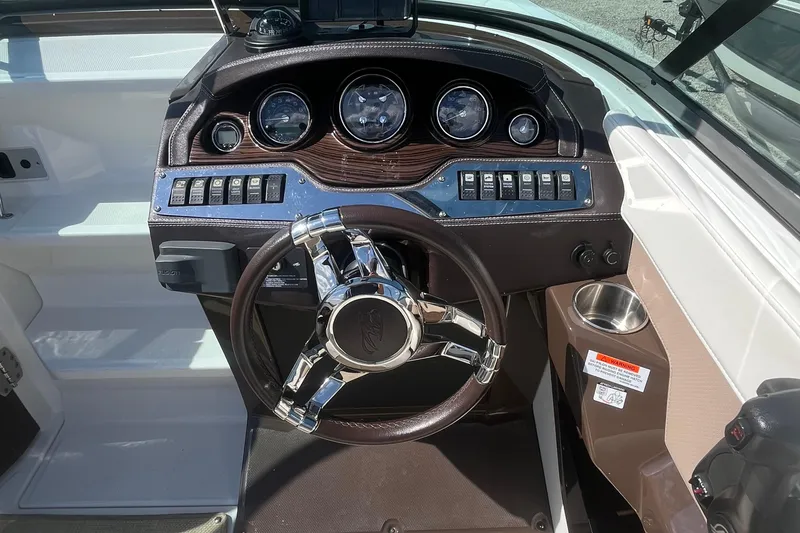 Slide: The Image of Steering console of a 2015 Monterey 268 SSC boat with gauges and controls. - 13