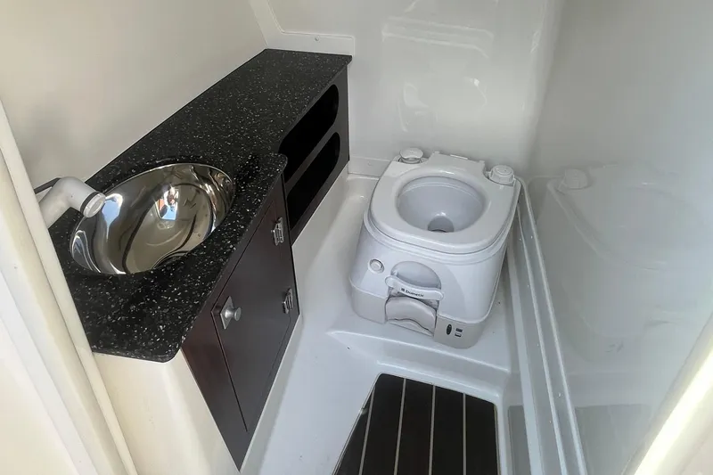 Slide: The Image of 2015 Monterey 268 SSC boat bathroom with sink and portable toilet. - 17