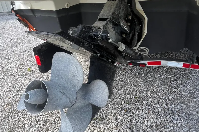 Slide: The Image of 2015 Monterey 268 SSC boat propeller and outdrive on gravel surface. - 4