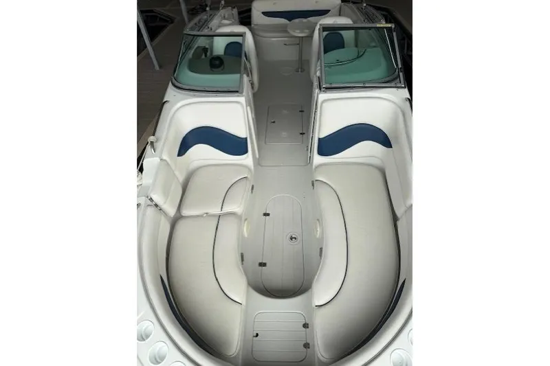 Slide: The Image of 2003 Crownline 239 DB boat interior with white and blue seating, spacious layout. - 10