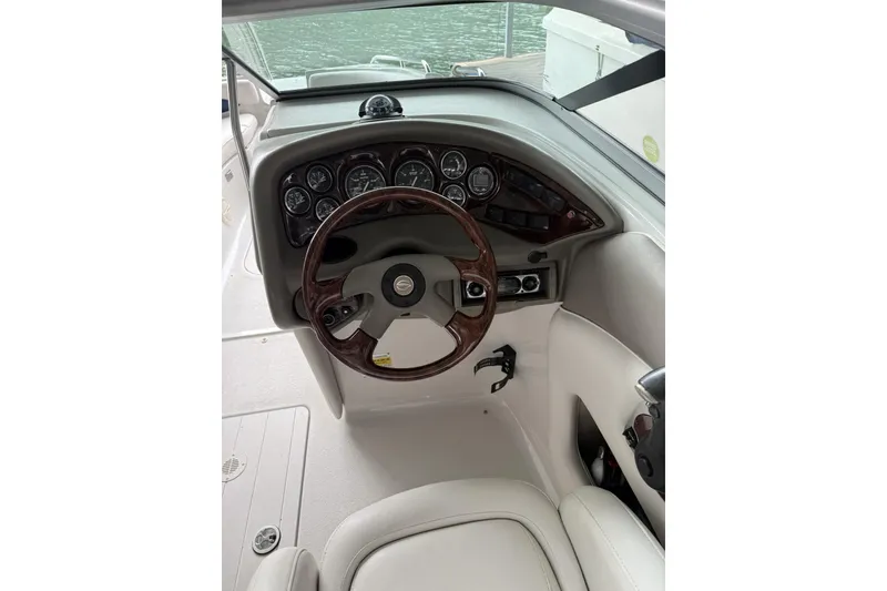 Slide: The Image of 2003 Crownline 239 DB boat dashboard with steering wheel and gauges. - 12
