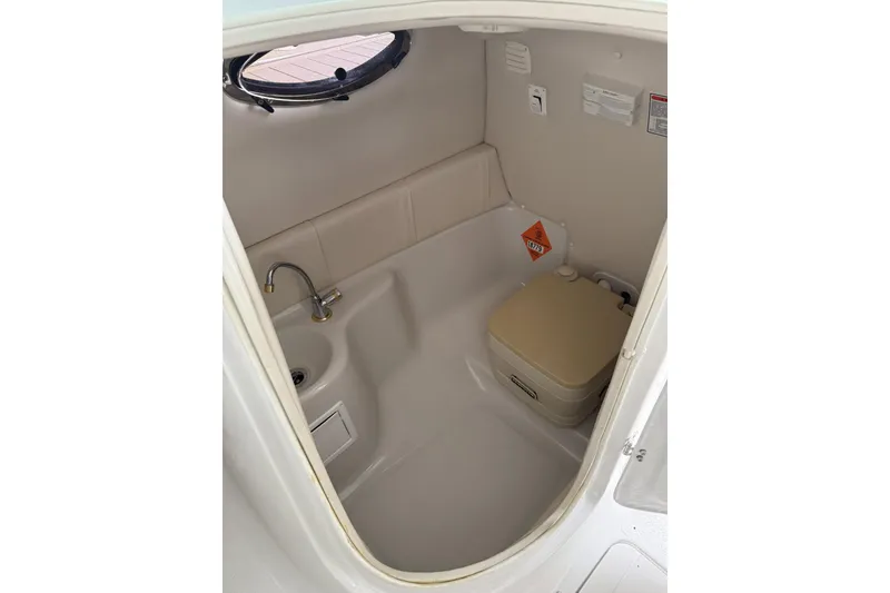 Slide: The Image of 2003 Crownline 239 DB boat interior with compact bathroom and sink. - 13