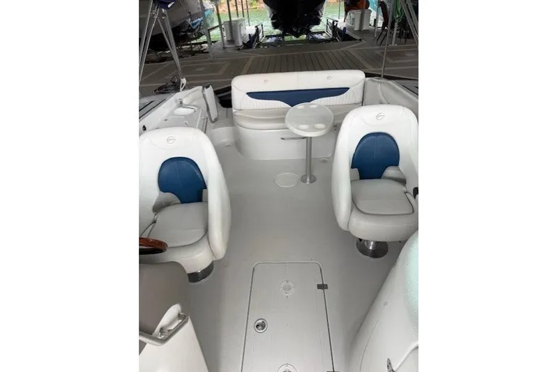 Slide: The Image of 2003 Crownline 239 DB boat interior with white and blue seating and a small table. - 8