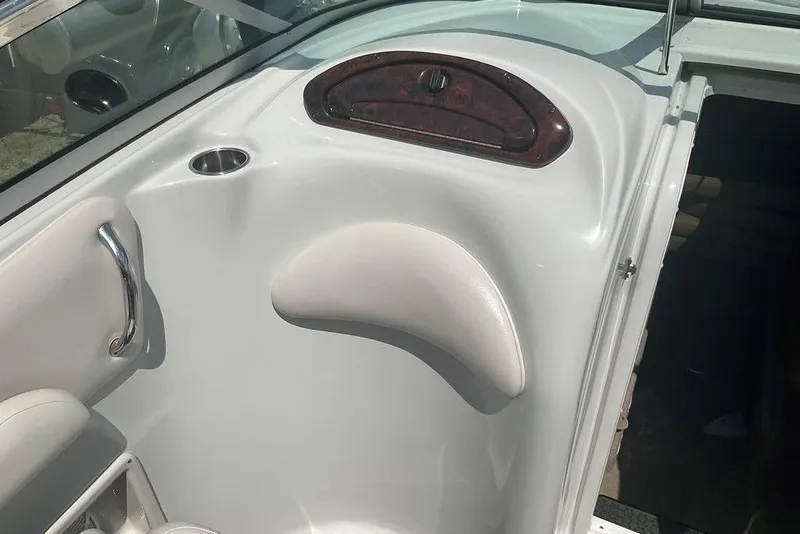 Slide: The Image of Interior of 2015 Crownline 236 SC boat, featuring sleek white design and cup holder. - 16