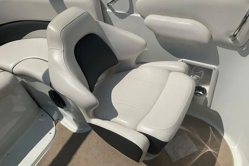 Slide: The Image of 2015 Crownline 236 SC boat interior with plush seating and cup holder. - 17