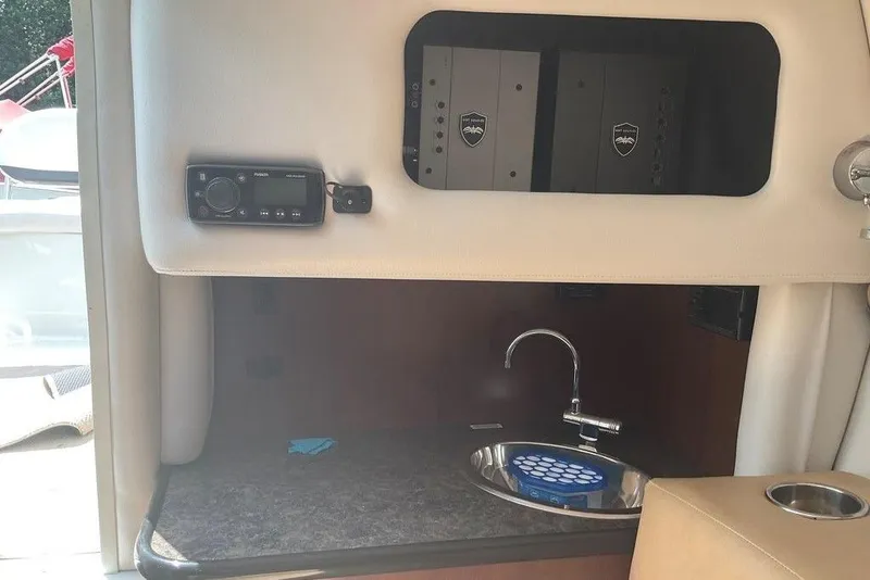 Slide: The Image of 2015 Crownline 236 SC boat interior with sink and control panel. - 18