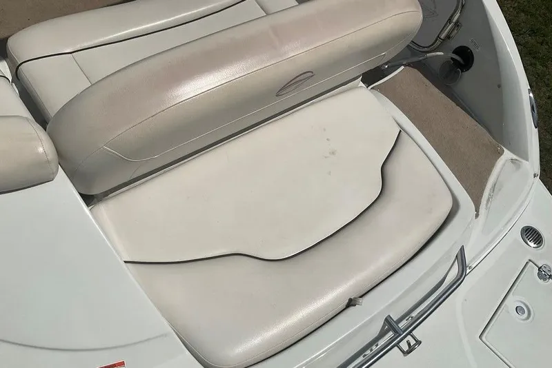 Slide: The Image of 2015 Crownline 236 SC boat interior seating, featuring white cushioned seats. - 20
