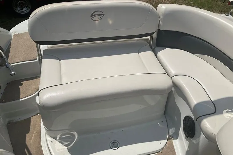 Slide: The Image of 2015 Crownline 236 SC boat interior with white cushioned seating. - 21