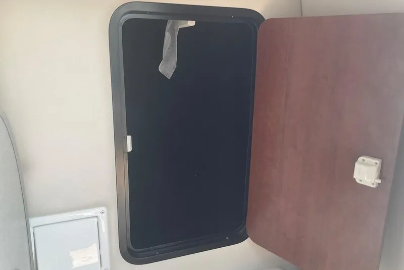 Slide: The Image of Open storage compartment inside 2015 Crownline 236 SC boat cabin. - 22