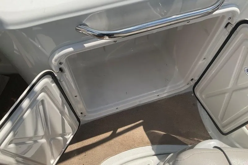 Slide: The Image of Open storage compartment on a 2015 Crownline 236 SC boat, featuring a sleek design. - 23