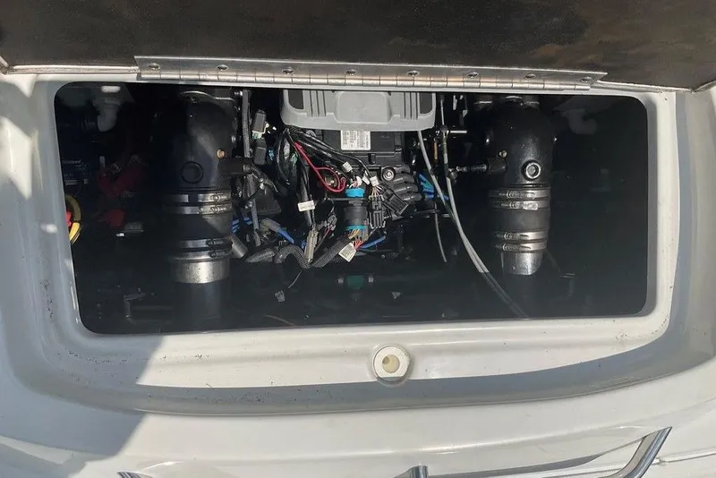 Slide: The Image of Engine compartment of a 2015 Crownline 236 SC boat, showcasing mechanical components. - 29