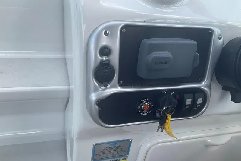 Slide: The Image of Control panel of a 2015 Crownline 236 SC boat with keys and switches. - 30