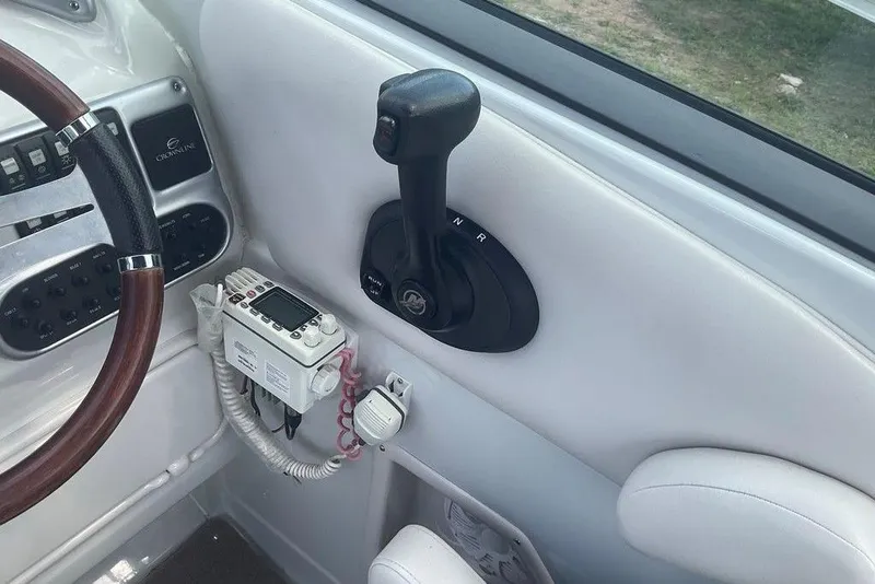Slide: The Image of 2015 Crownline 236 SC boat cockpit with steering wheel and control panel. - 31