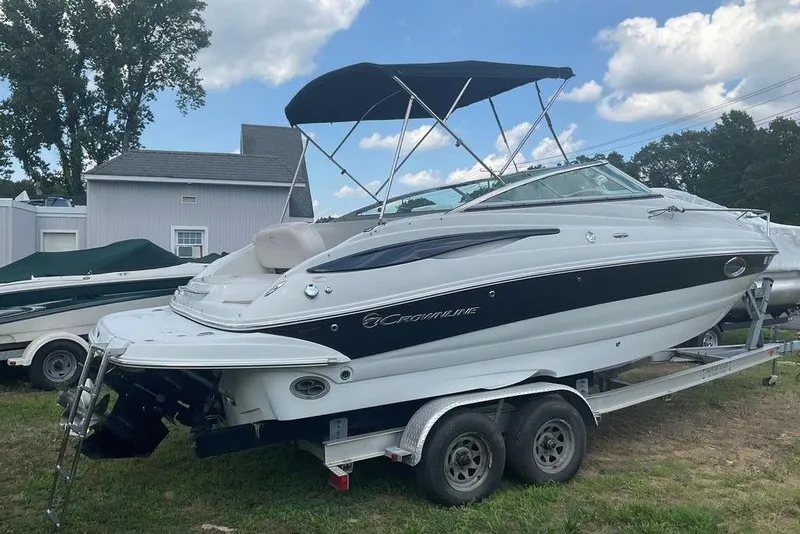 Slide: The Image of 2015 Crownline 236 SC boat on trailer, parked outdoors under blue sky. - 6