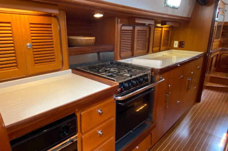 Slide: The Image of Luxurious wooden kitchen interior of 2006 Passport 470 yacht with stove and cabinets. - 11