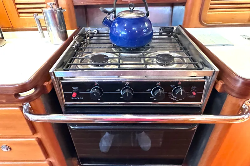 Slide: The Image of Stove with blue kettle in a Passport 470 yacht kitchen, 2006 model. - 14