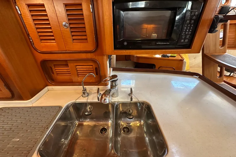 Slide: The Image of Galley kitchen in 2006 Passport 470 yacht with sink and microwave. - 16