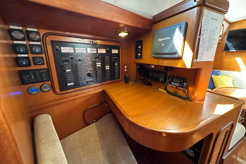 Slide: The Image of 2006 Passport 470 yacht navigation station with control panels and communication equipment. - 19