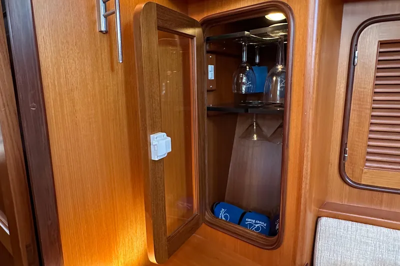 Slide: The Image of Wooden cabinet with glassware inside, aboard a 2006 Passport 470 yacht. - 21