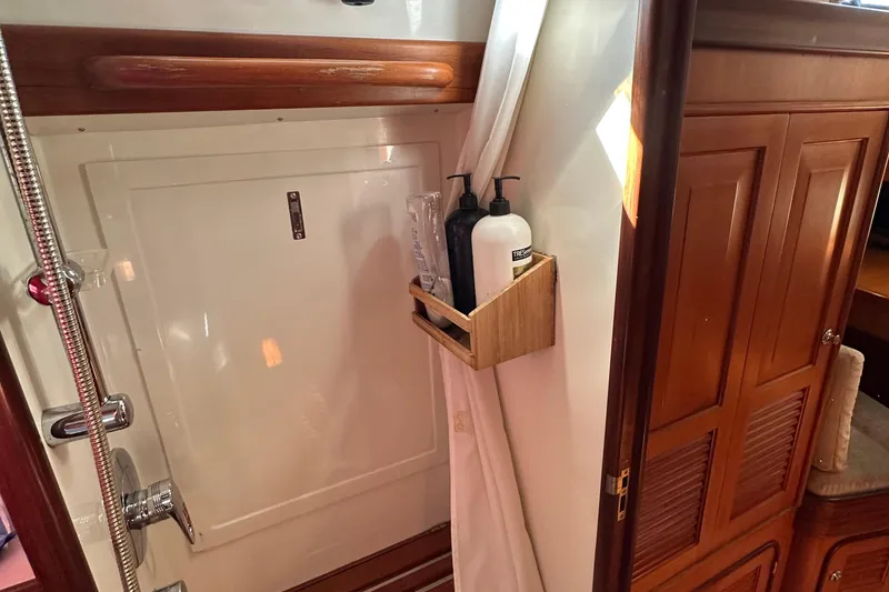 Slide: The Image of Shower area in 2006 Passport 470 yacht with wooden accents and toiletries. - 32