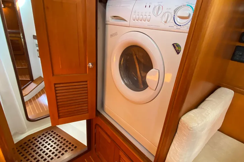 Slide: The Image of Compact laundry area with a washing machine in a 2006 Passport 470 yacht. - 33