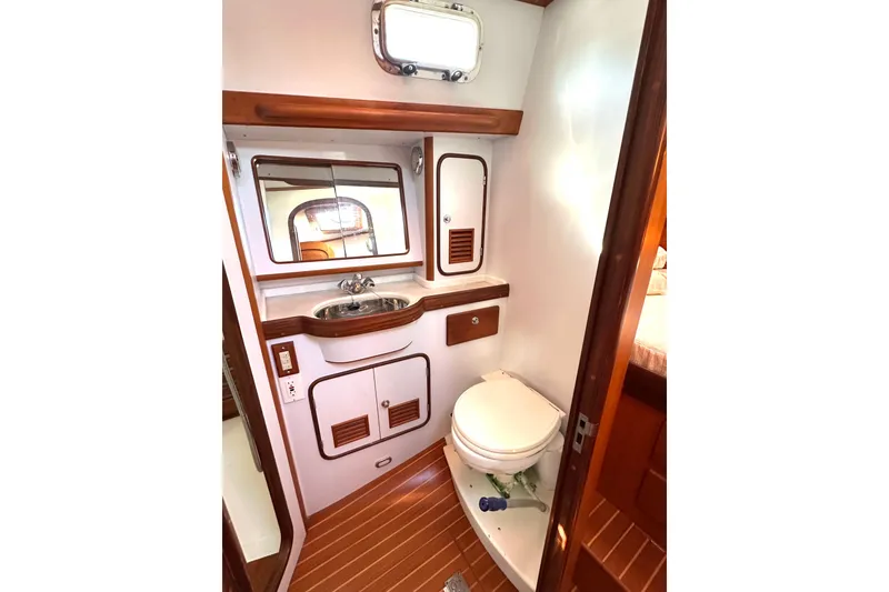 Slide: The Image of Luxurious 2006 Passport 470 yacht bathroom with wooden accents and modern fixtures. - 35