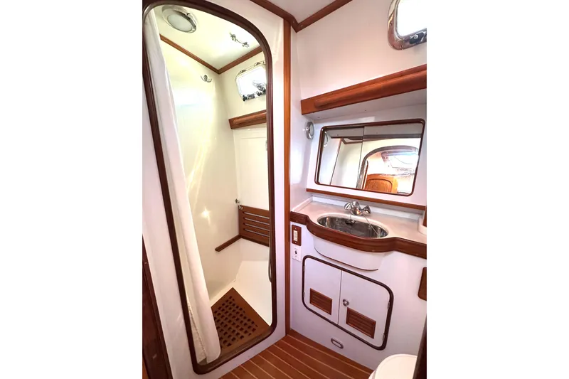 Slide: The Image of Luxurious 2006 Passport 470 yacht bathroom with wood accents and modern fixtures. - 36