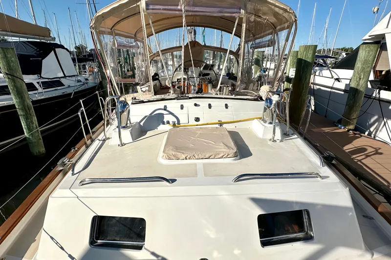 Slide: The Image of Sailboat docked at marina, Passport 470 model, 2006, with covered cockpit area. - 40