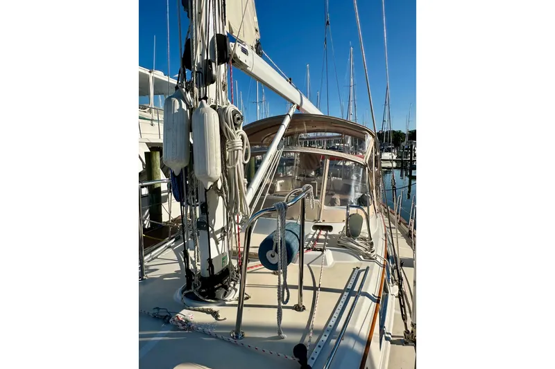 Slide: The Image of Sailboat deck view of 2006 Passport 470 in marina, featuring rigging and cockpit. - 41
