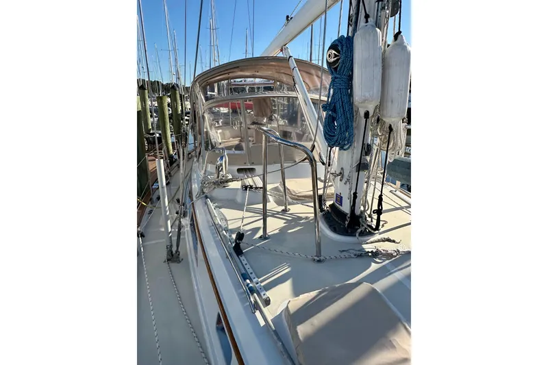 Slide: The Image of Sailboat deck view of 2006 Passport 470, featuring rigging and cockpit area. - 42