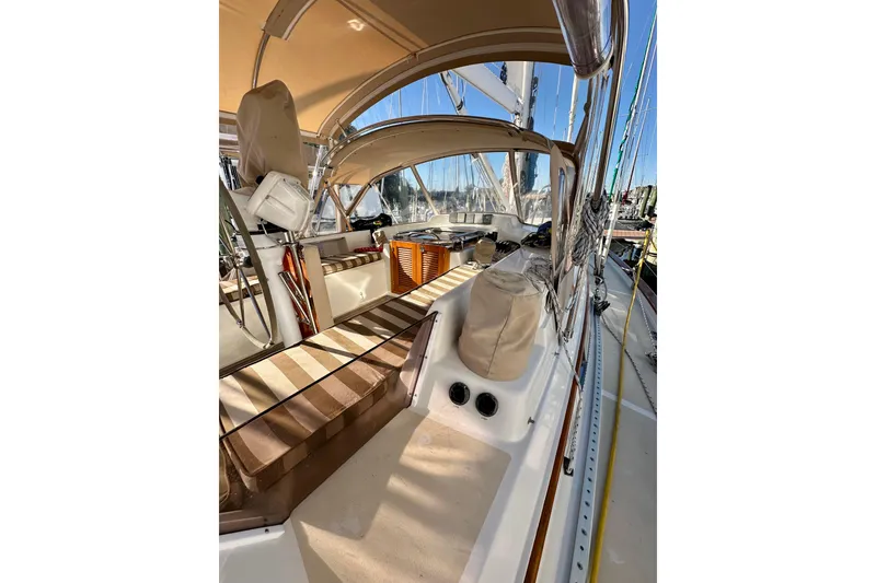 Slide: The Image of 2006 Passport 470 sailboat deck with striped seating and protective canopy. - 43