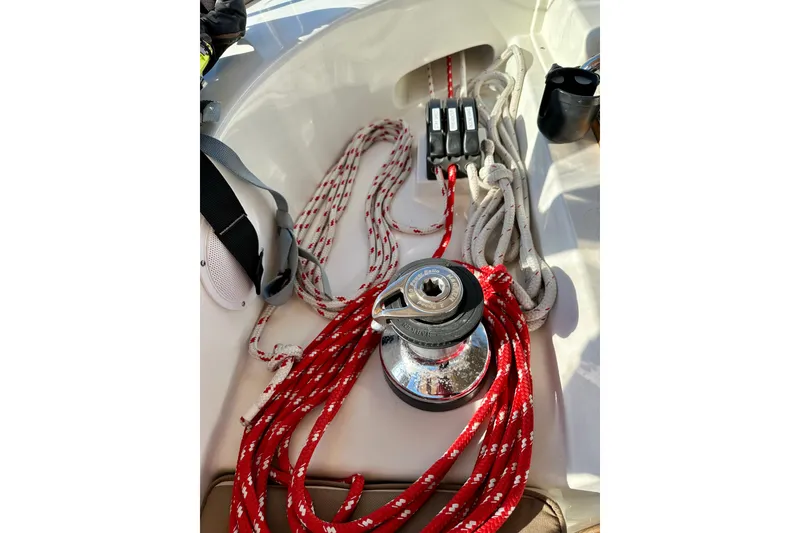 Slide: The Image of Sailing equipment on a 2006 Passport 470 yacht, featuring ropes and a winch. - 46
