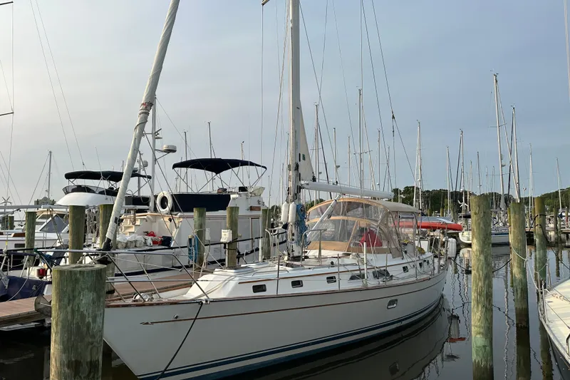 Slide: The Image of Sailboat docked at marina, Passport 470 model, 2006, surrounded by other boats. - 5