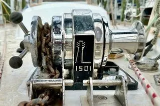 Slide: The Image of Chrome winch on 2006 Passport 470 sailboat deck, featuring chain and control levers. - 51