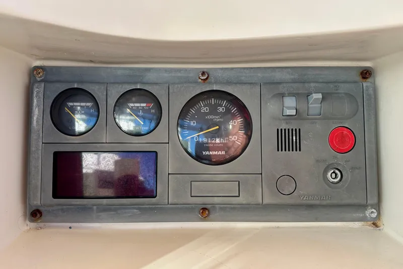 Slide: The Image of Control panel of a 2006 Passport 470 boat with Yanmar engine gauges. - 53