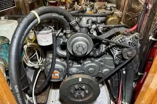 Slide: The Image of Engine of a 2006 Passport 470 boat, showcasing mechanical components and hoses. - 55