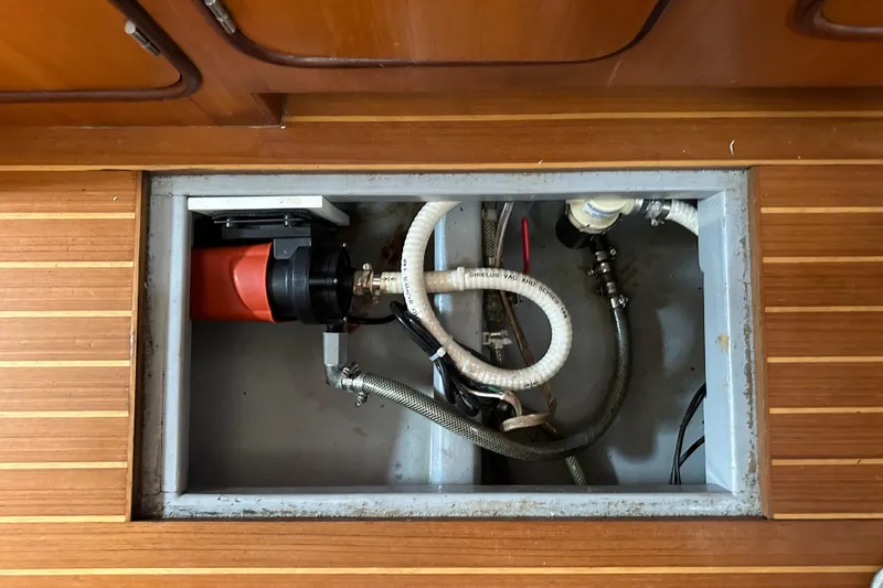 Slide: The Image of Bilge pump system in a 2006 Passport 470 yacht, with wooden flooring. - 62