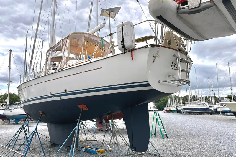 Slide: The Image of Sailboat Passport 470, 2006 model, docked in a marina with overcast skies. - 67