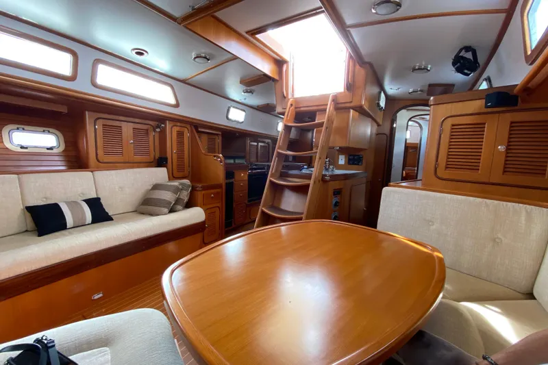 Slide: The Image of Luxurious 2006 Passport 470 yacht interior with wooden finishes and comfortable seating. - 7