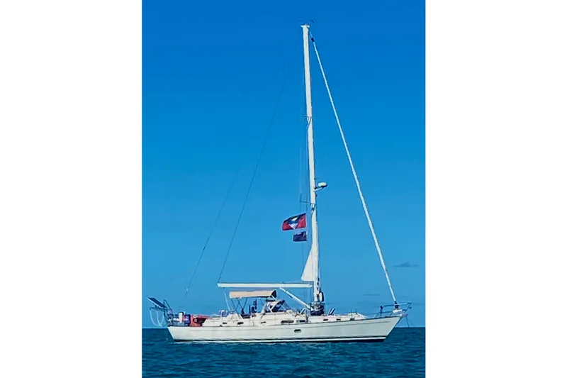 Slide: The Image of Sailboat on open water, 2006 Passport 470 model, under clear blue sky. - 72