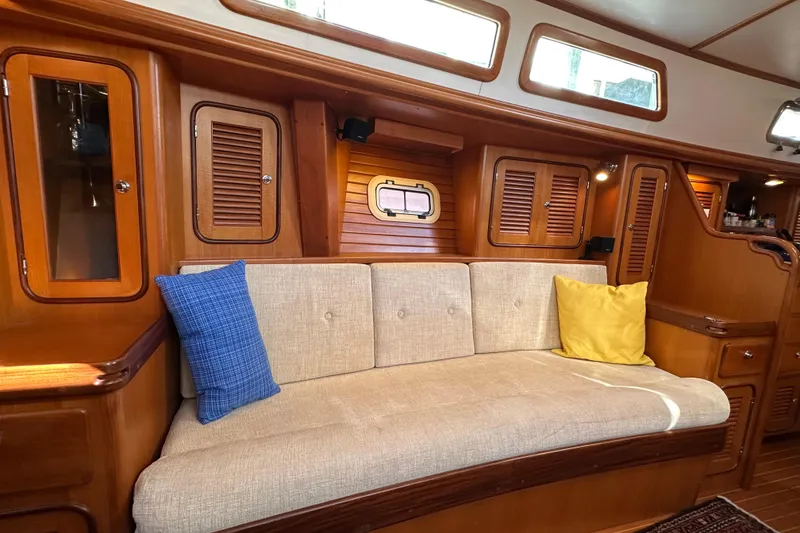 Slide: The Image of Luxurious 2006 Passport 470 yacht interior with cozy seating and vibrant cushions. - 8